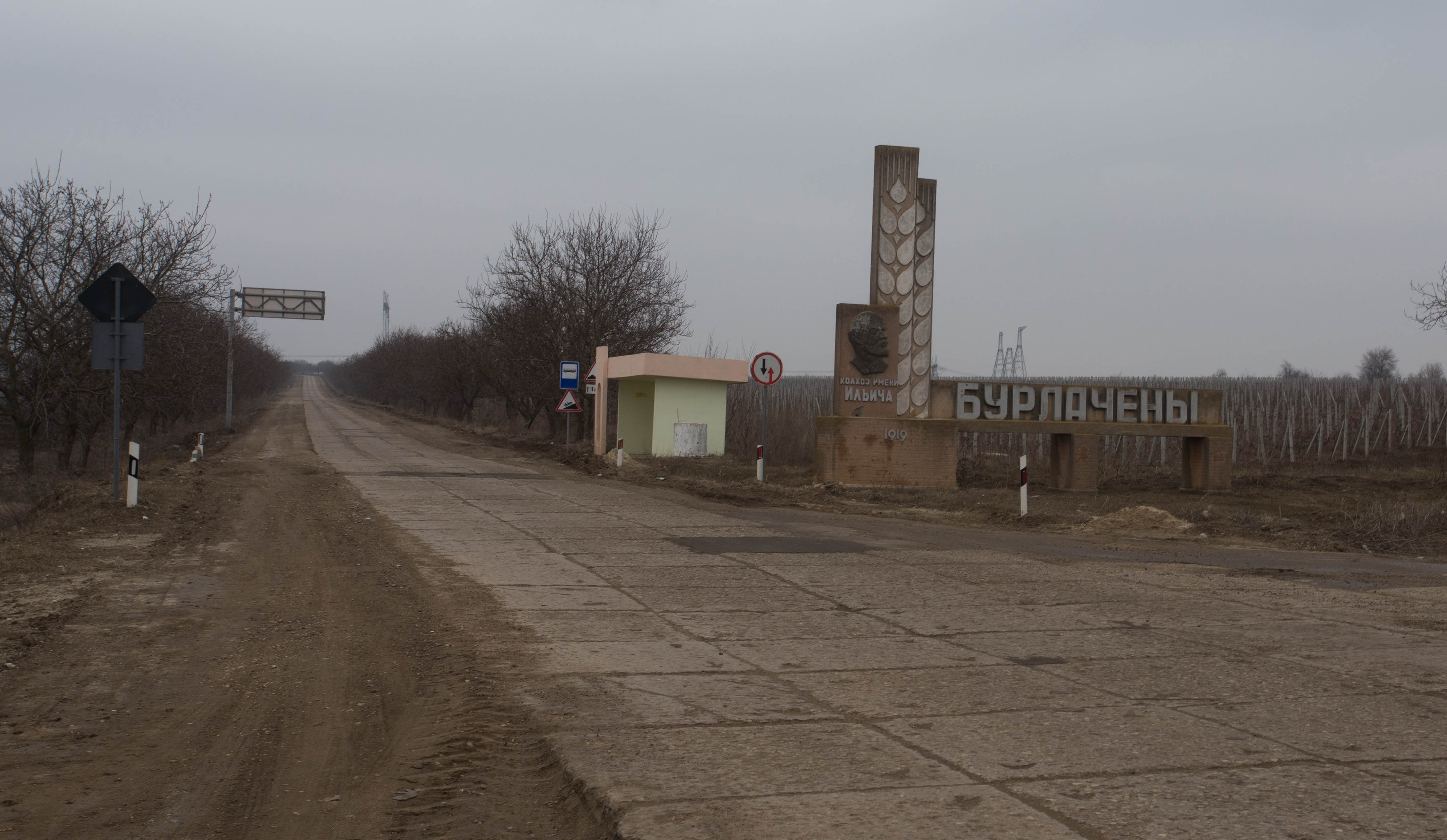 The bleakness of southern Moldova in winter: grey skies, battered roads, brown torn up earth and monuments to Lenin